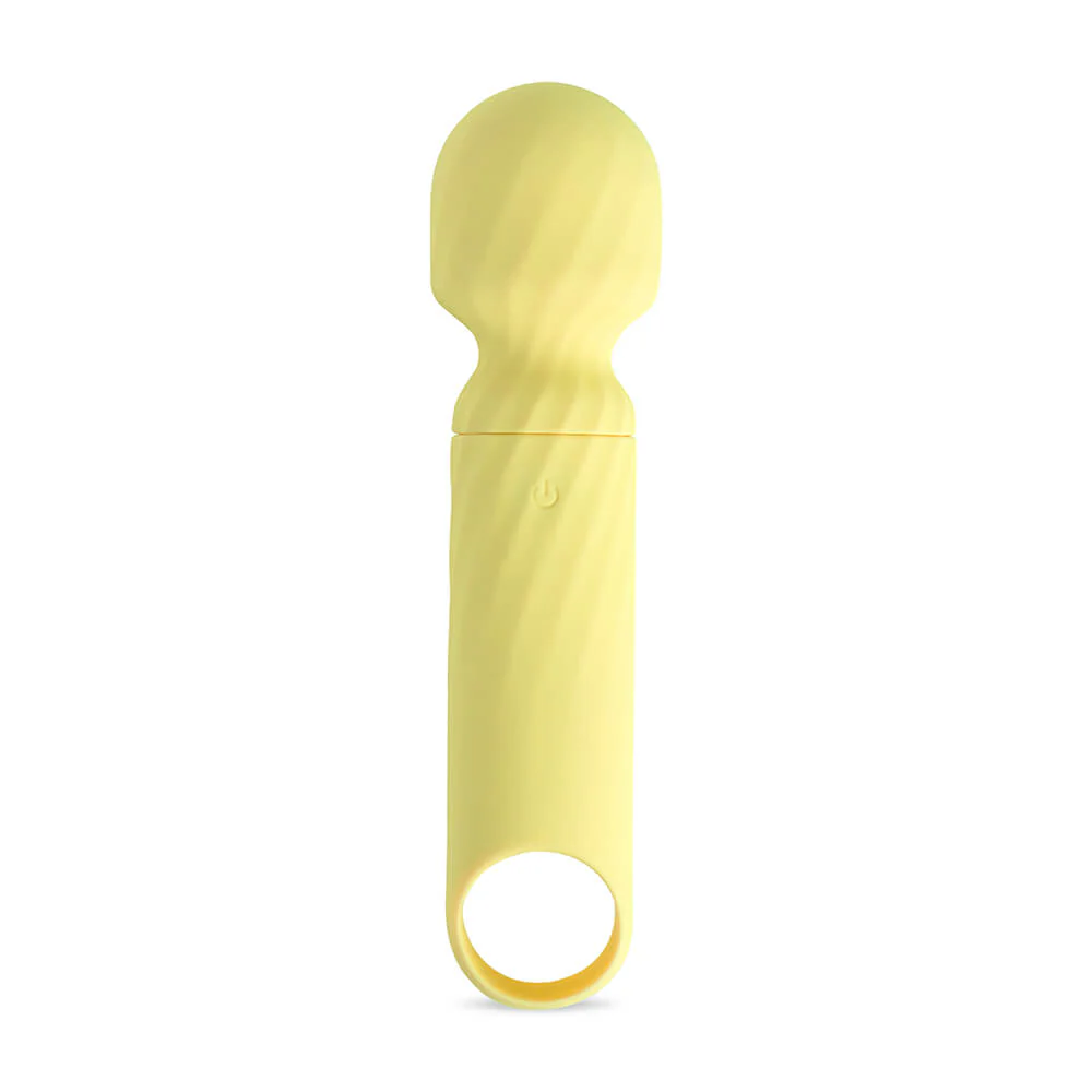 Massageador facial de silicone amarelo para cuidados de pele.