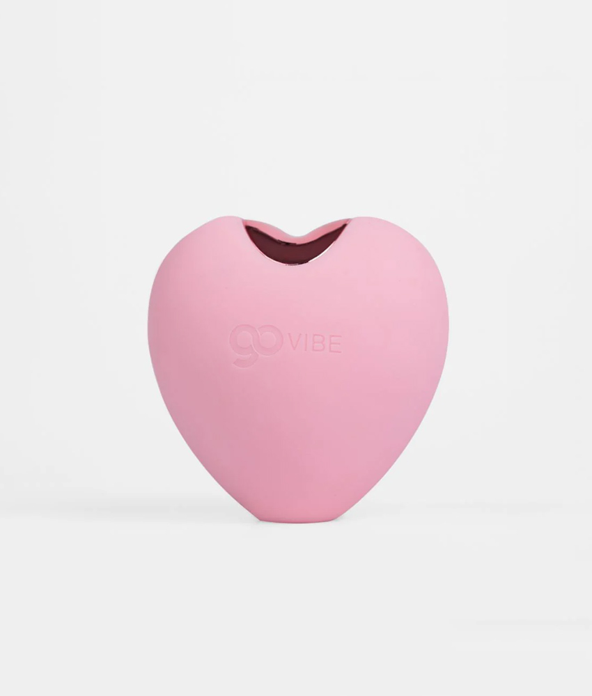 Vibrador em formato de coração rosa para estímulo íntimo.